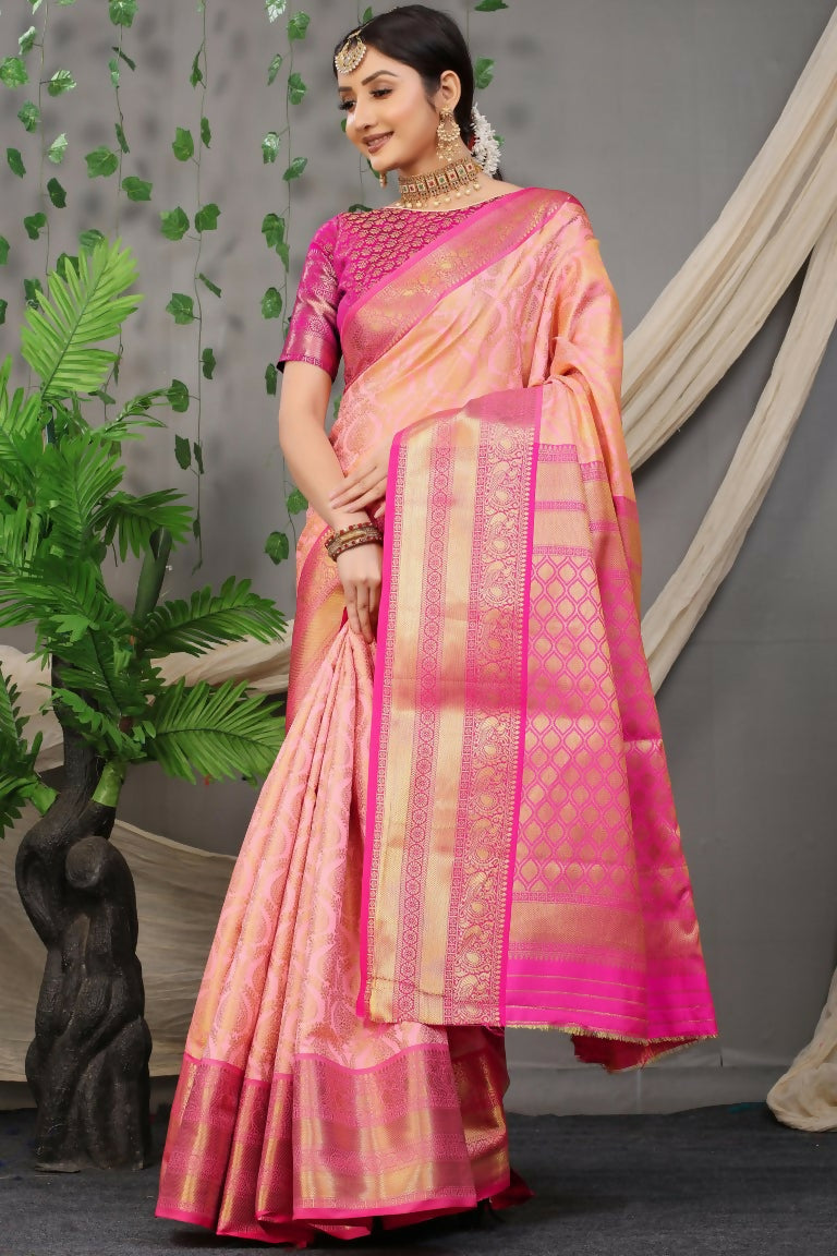 Peach Kanjivaram silk saree with traditional zari work and contrasting pink blouse.