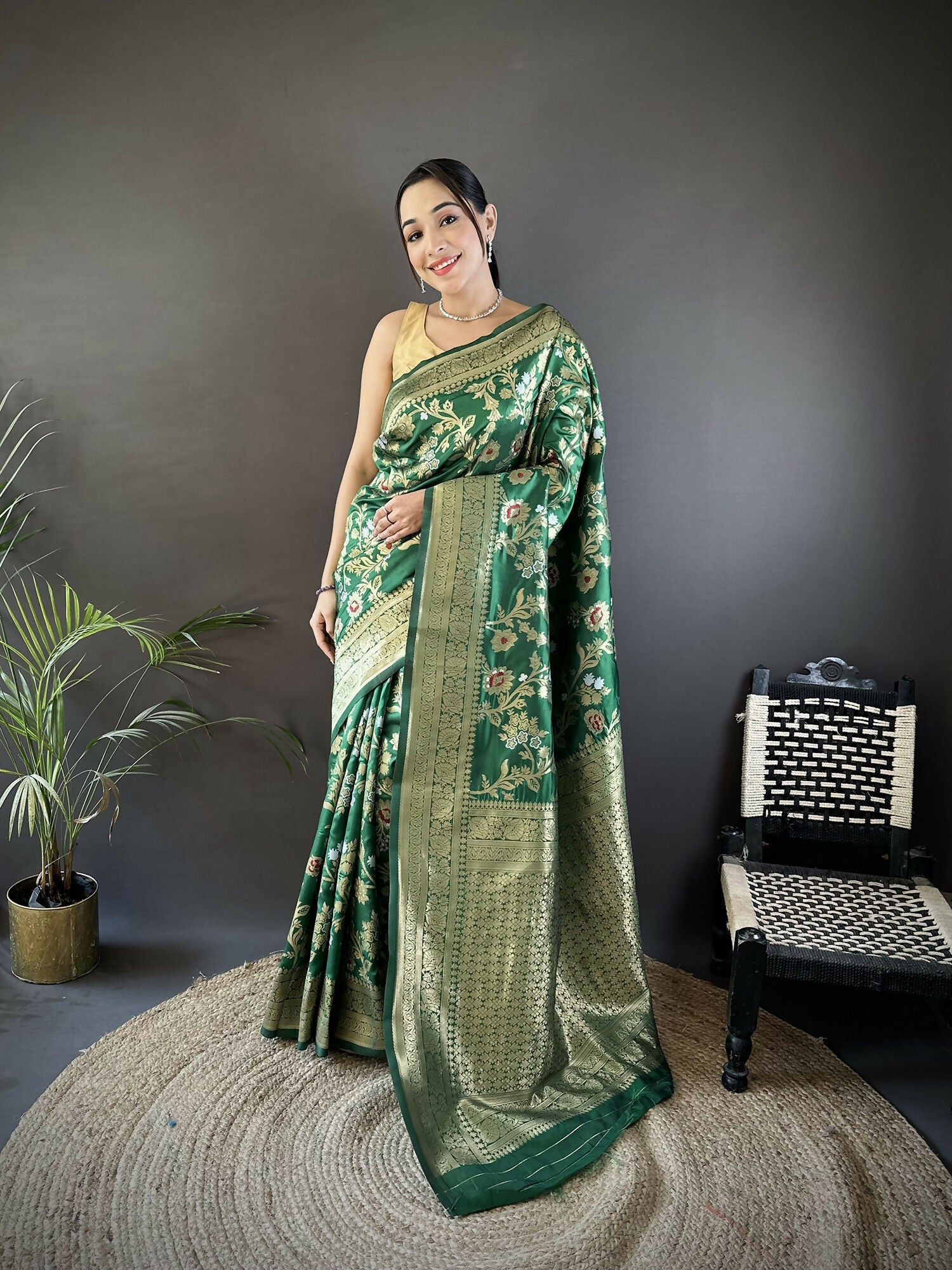 A luxurious green soft silk Banarasi saree with intricate Meenakari floral and ethnic motifs and a matching blouse piece.