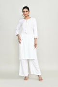 Woman wearing a white embroidered rayon kurta set with palazzo pants