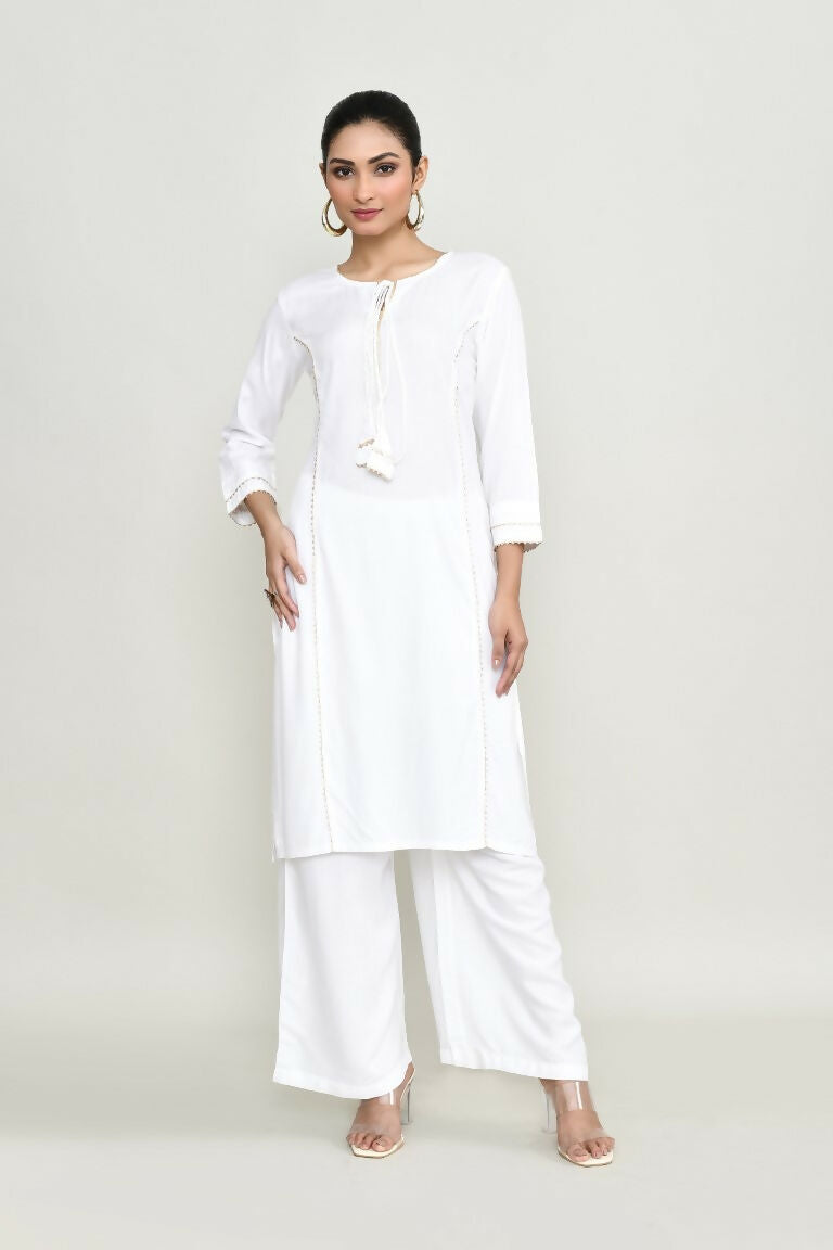 Woman wearing a white embroidered rayon kurta set with palazzo pants