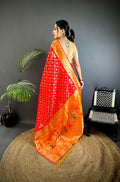 Red soft silk Patola saree featuring delicate butti motifs and matching blouse