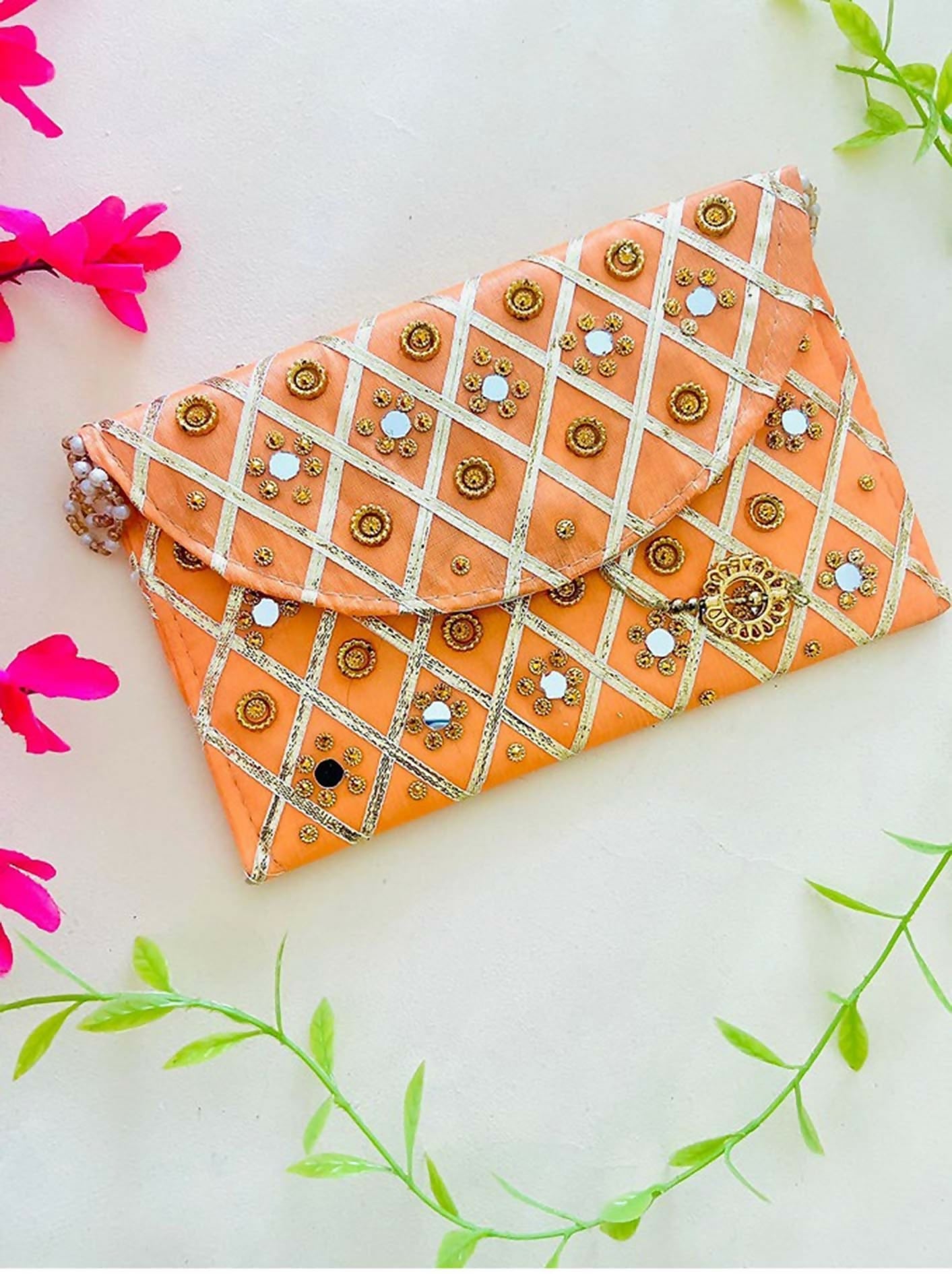 Vibrant orange structured clutch bag with magnetic closure