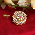 A beautiful gold-polished adjustable finger ring adorned with delicate white pearls.
