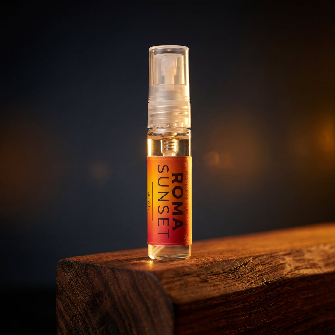 2mL glass sample vial of Roma Sunset Extrait de Parfum with amber-toned liquid