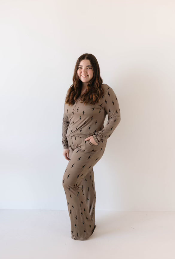 Woman wearing a brown and black lightning bolt print long sleeve bamboo pajama set