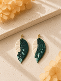 Handmade Alocasia Melo Albo botanical earrings with green and cream textured leaf design.