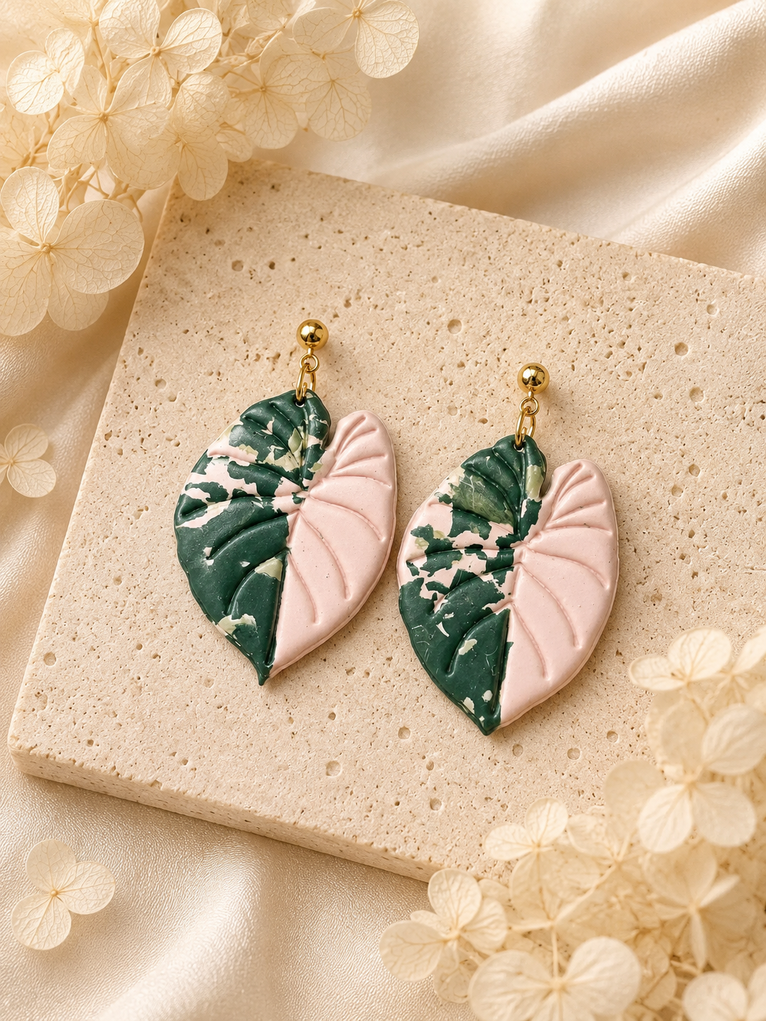 Pink Alocasia Serendipity leaf-shaped earrings made from polymer clay
