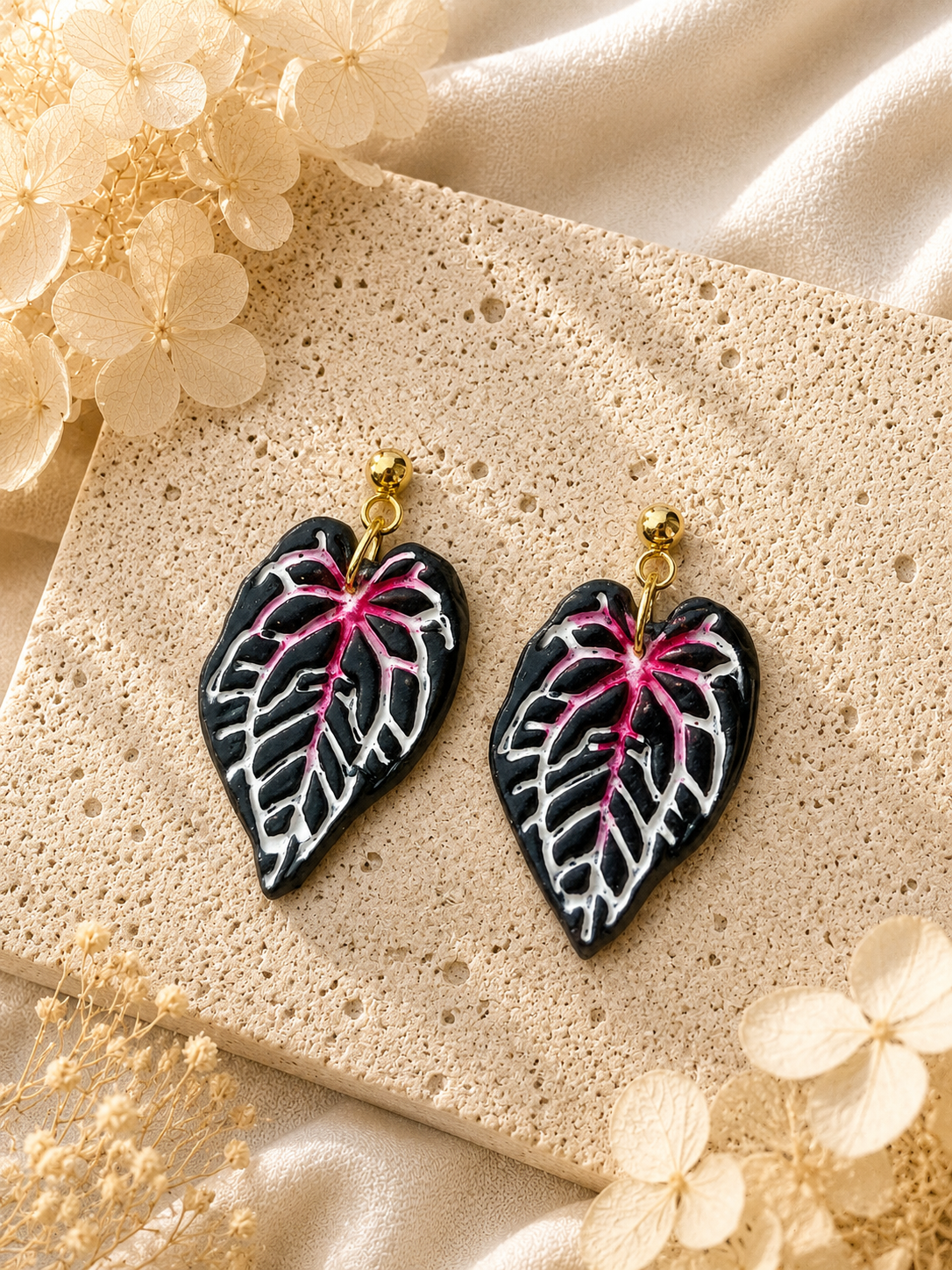 Red Crystal Anthurium leaf earrings with hand-painted vein detail.