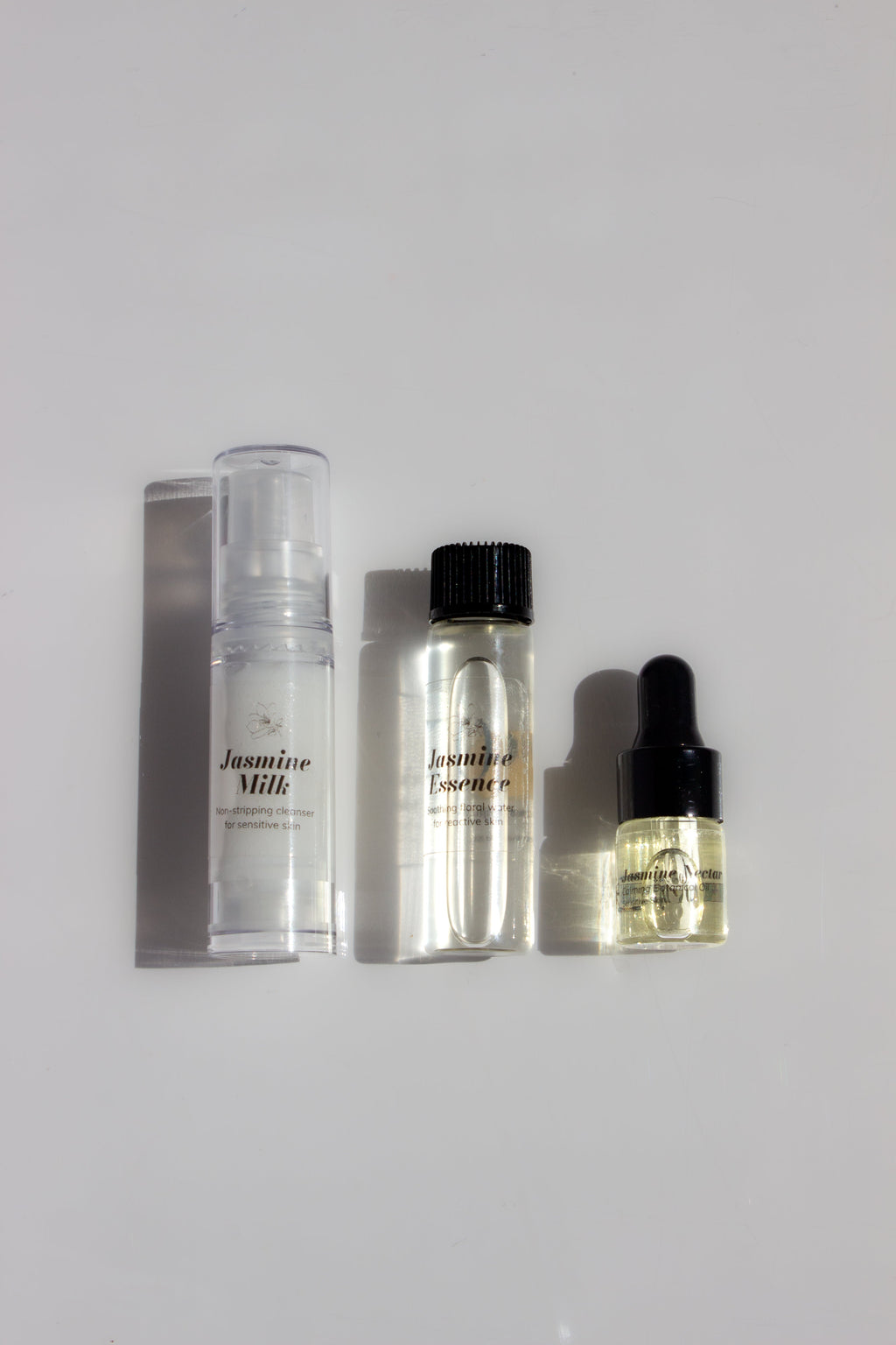 Orijin Jasmine trial kit featuring Jasmine Milk cleanser, Jasmine Essence floral water, and Jasmine Nectar oil in a travel pouch.