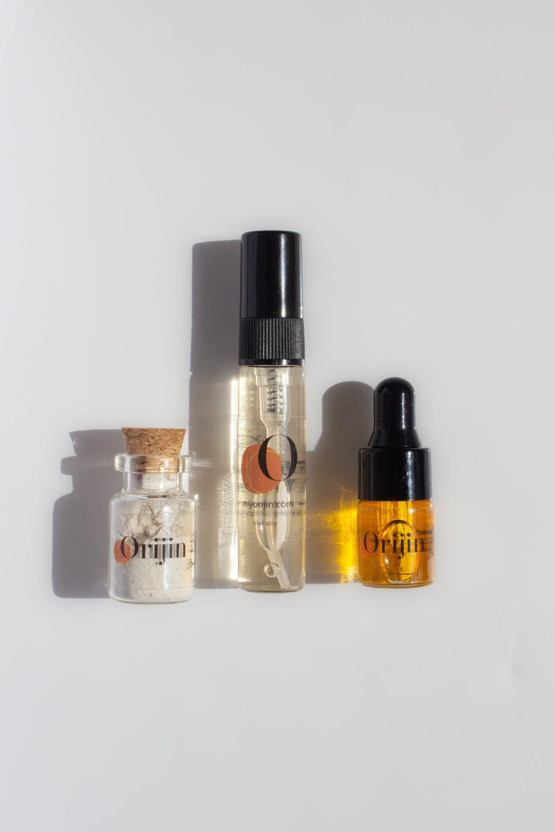 Orijin Hibiscus glow ritual trial and travel kit including three mini skincare bottles and colorful packaging.
