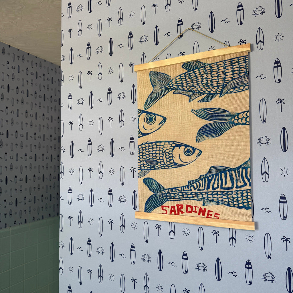 Surfs Up nautical wallpaper in light-blue and navy-blue for a coastal themed child's room.