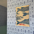 Surfs Up nautical wallpaper in light-blue and navy-blue for a coastal themed child's room.