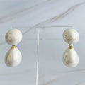 White glass pearl teardrop earrings with 18k gold plated brass findings on an Ellison + Young display card