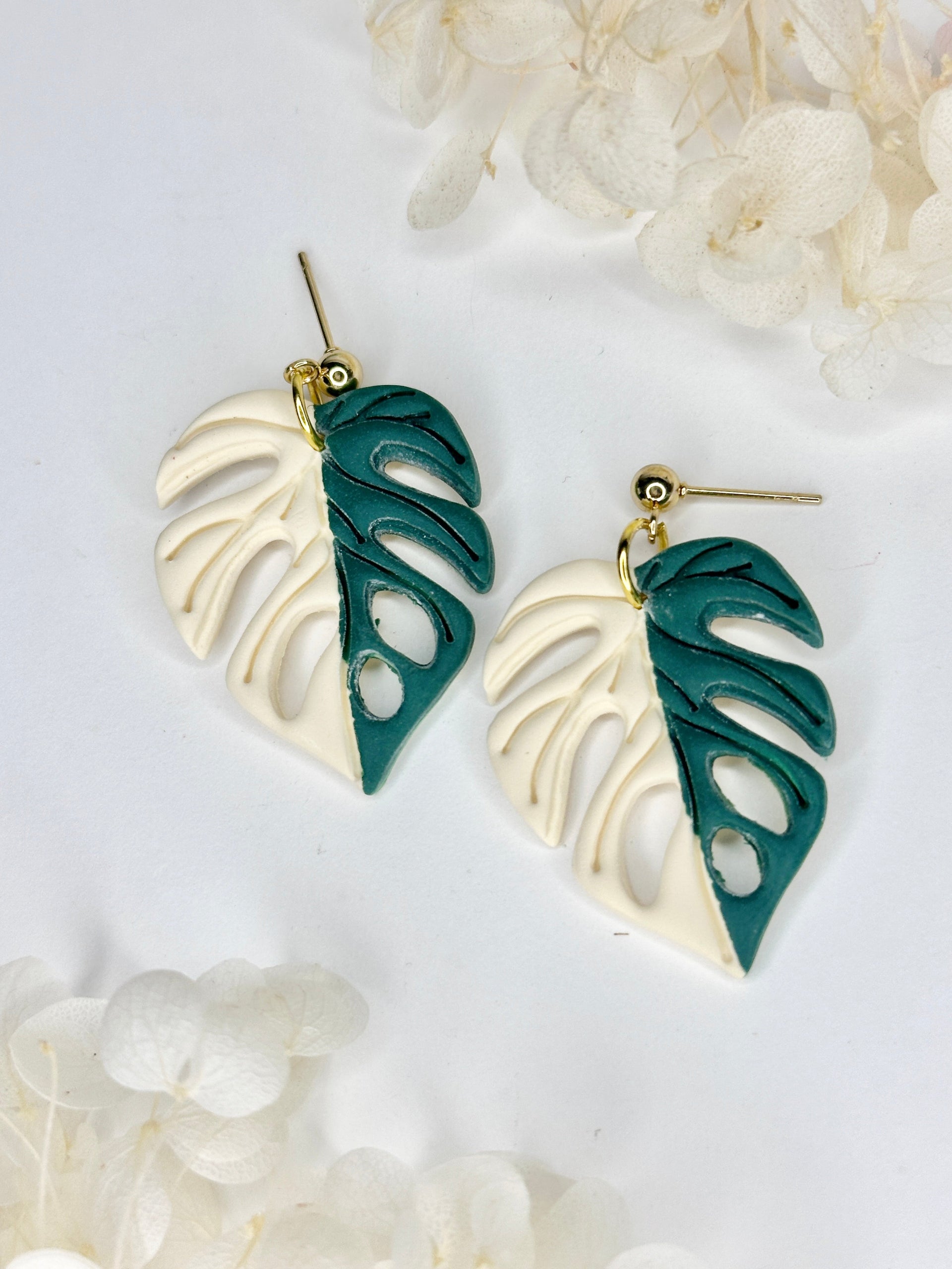 Artisanal Half Moon Monstera statement earrings with creamy white and jade marble finish on gold-plated posts.