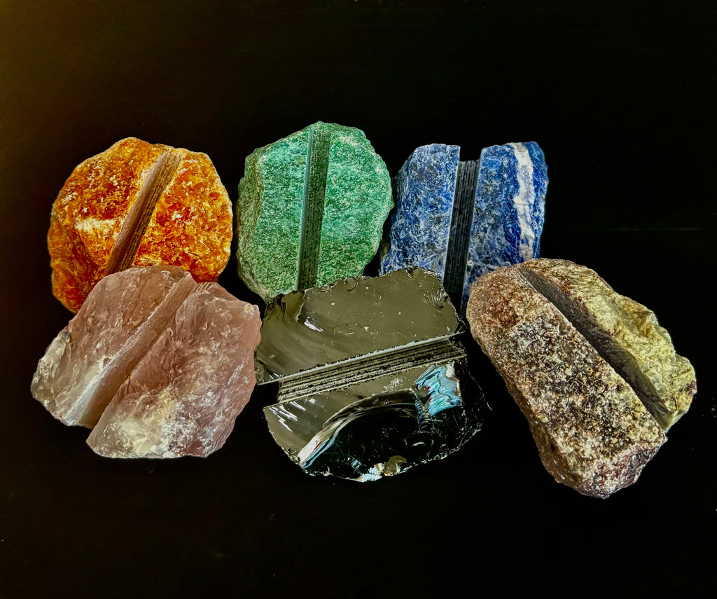 A raw natural crystal business card holder sitting on a modern office desk.