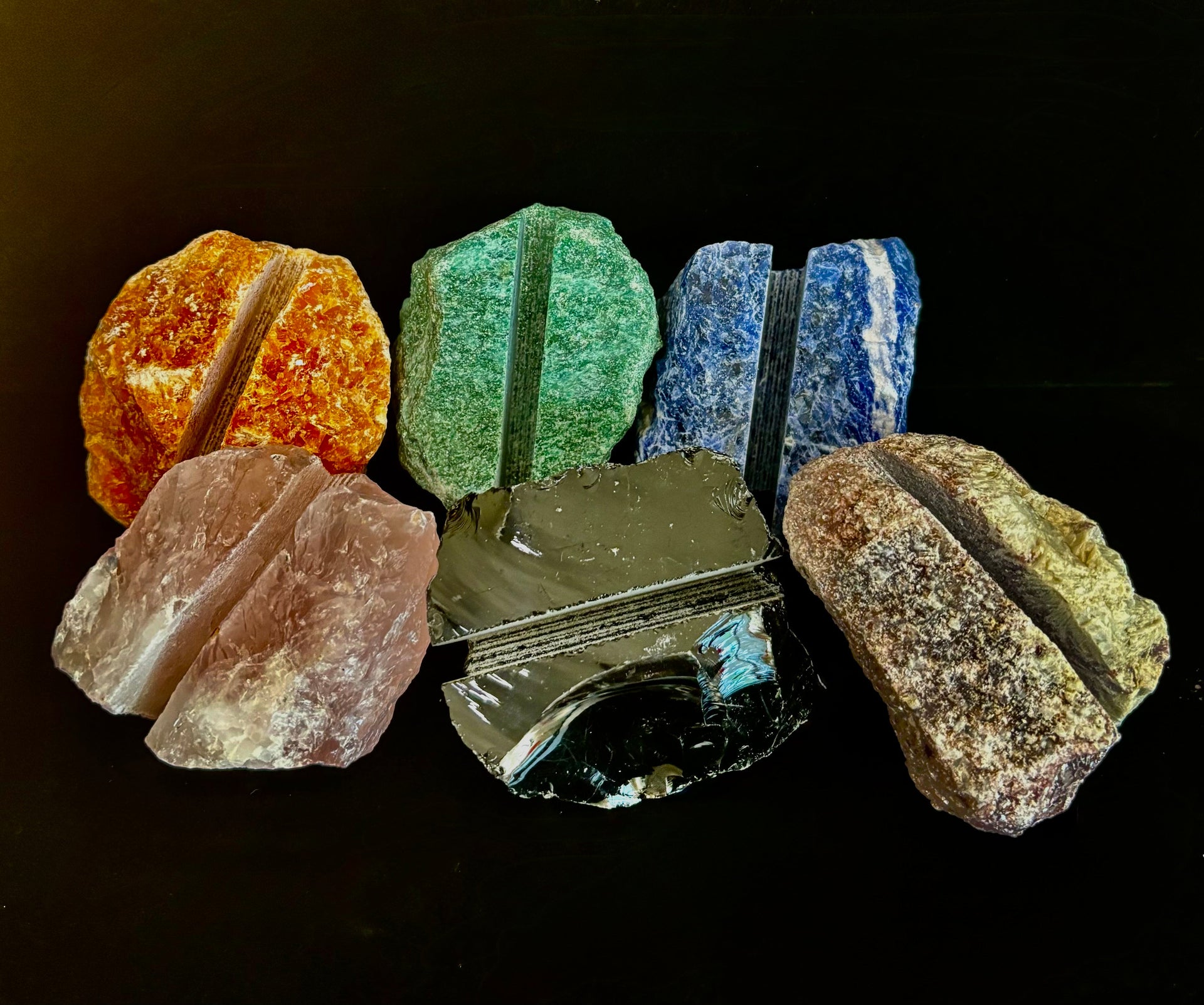 A raw natural crystal business card holder sitting on a modern office desk.