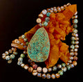 Close up of a Desert Oasis Jade teardrop pendant necklace with gold-plated bezel and bohemian beaded chain