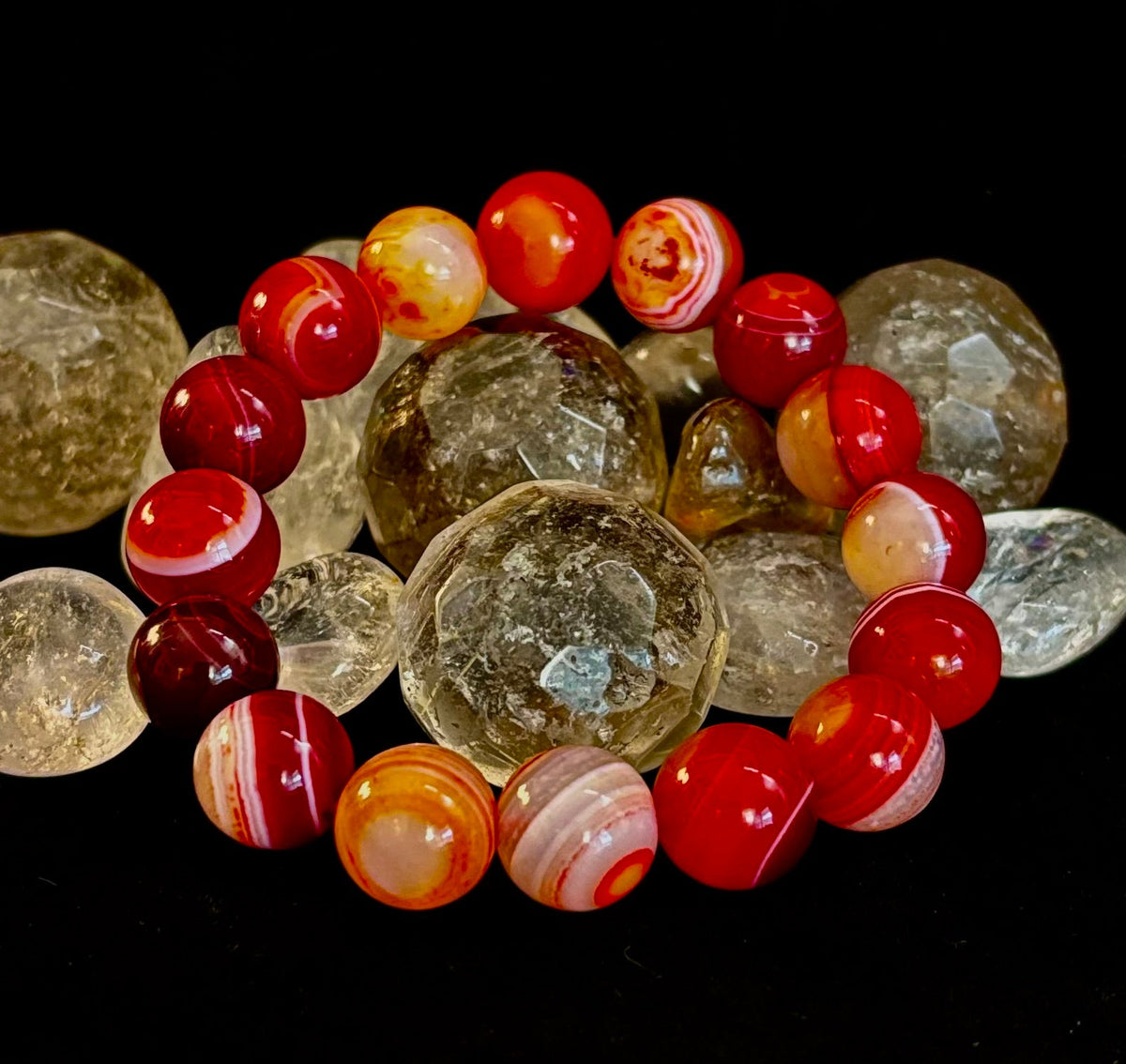 Fiery Spirit Red Banded Agate stretch bracelet featuring vibrant red and white swirling stone patterns.