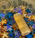 Minimalist selenite crystal keychain with silver hardware on a neutral background
