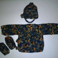 Close up of a handmade crochet newborn duster style cardigan in a cozy knit texture.
