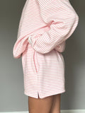 Light Pink and White Big Striped unisex shorts worn for a casual summer look