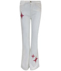 White stretch denim jeans featuring rose gold glitter star graphics on the leg.
