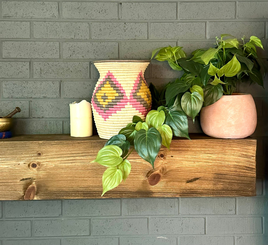 Round wicker Joy Vessel basket with geometric pattern in pink, cream, mustard, and grey.