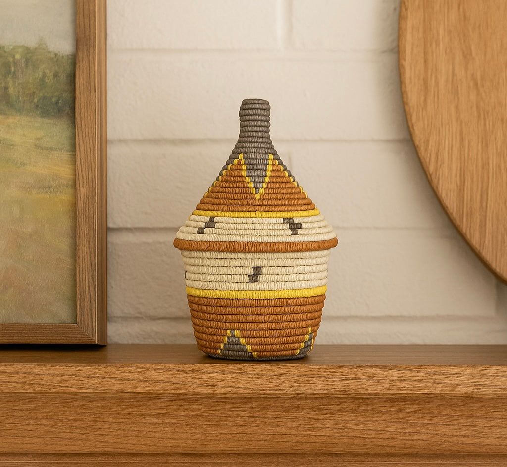 Large geometric Rwandan-style storage basket in natural, charcoal-grey, mustard, and burnt sienna.