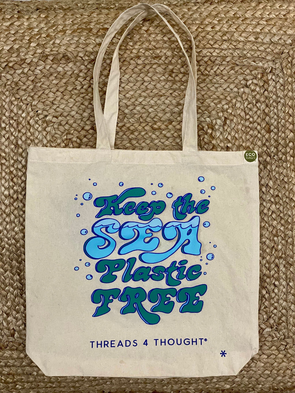 Keep The Sea Plastic Free eco-friendly cotton tote bag in beige, blue, and green tones.