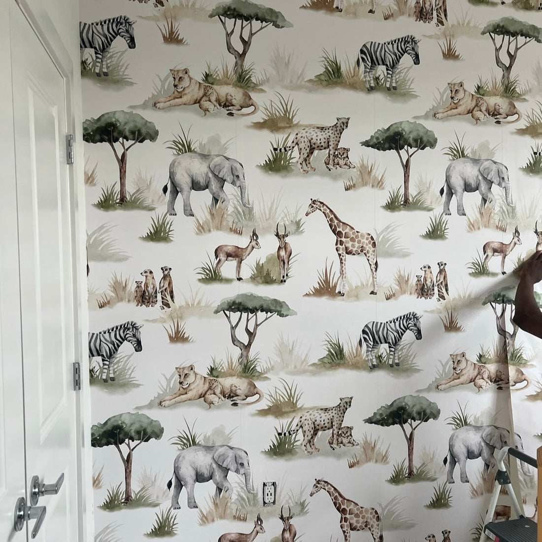 Safari-themed Lionel wallpaper with whimsical green and brown animal print pattern on a white background.