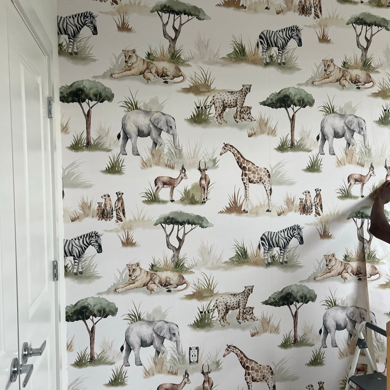 Safari-themed Lionel wallpaper with whimsical green and brown animal print pattern on a white background.