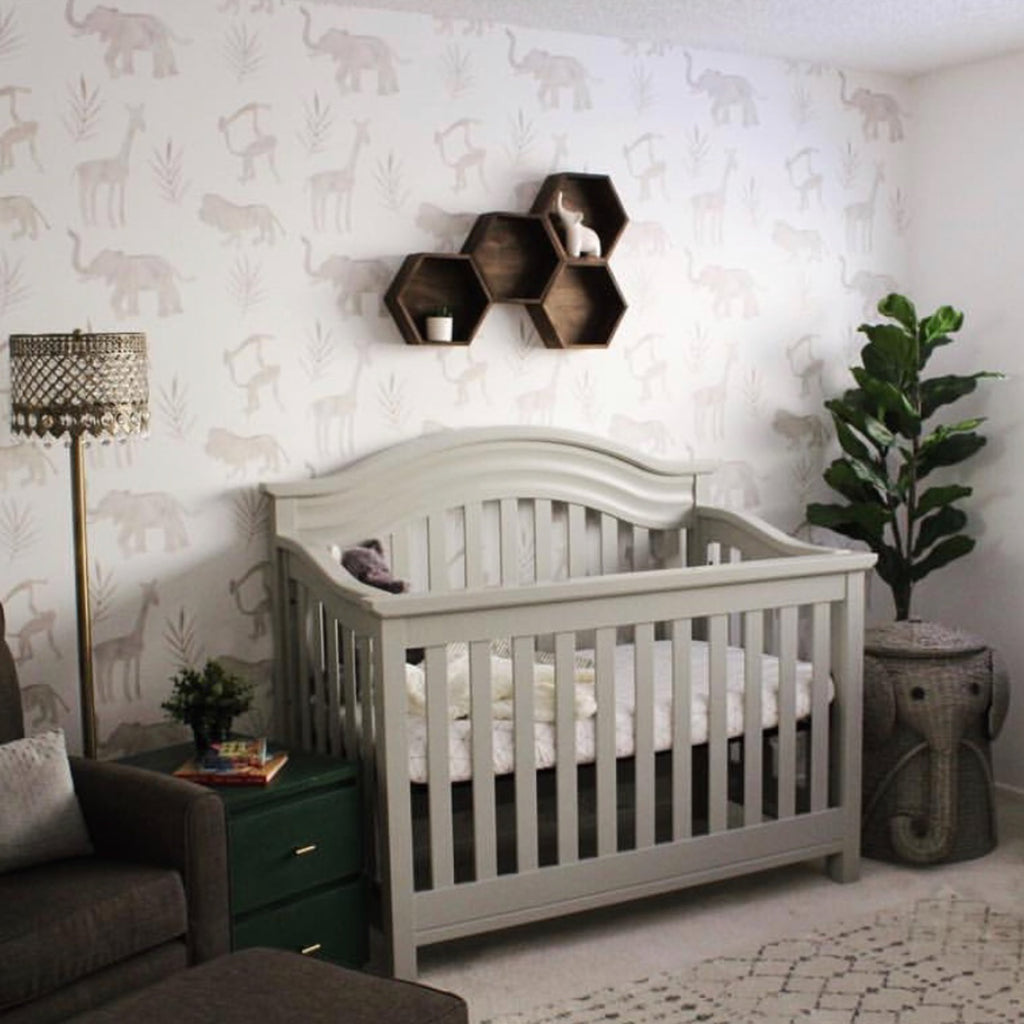 Simba Safari animal print wallpaper in taupe and white on a nursery wall