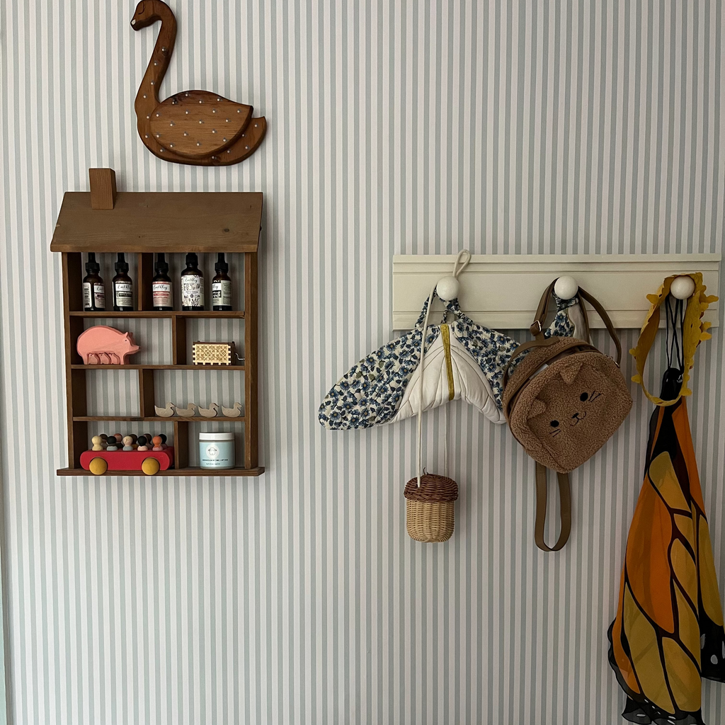 Close up of Meyer Pinstripe Wallpaper in neutral beige and cream tones featuring a minimalist striped pattern.