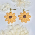 Close up of Golden Hour Petals daisy accessory in warm golden tones