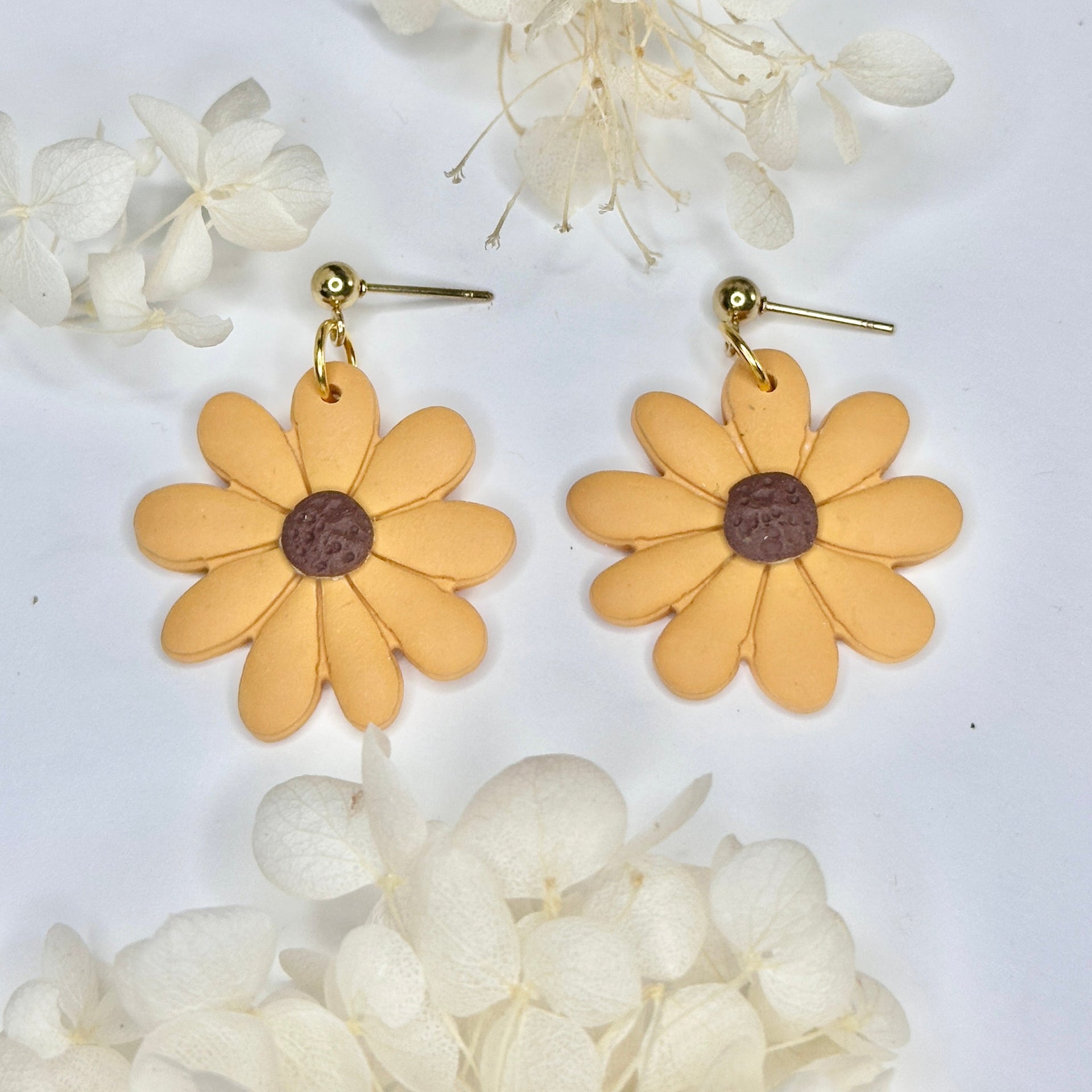 Close up of Golden Hour Petals daisy accessory in warm golden tones