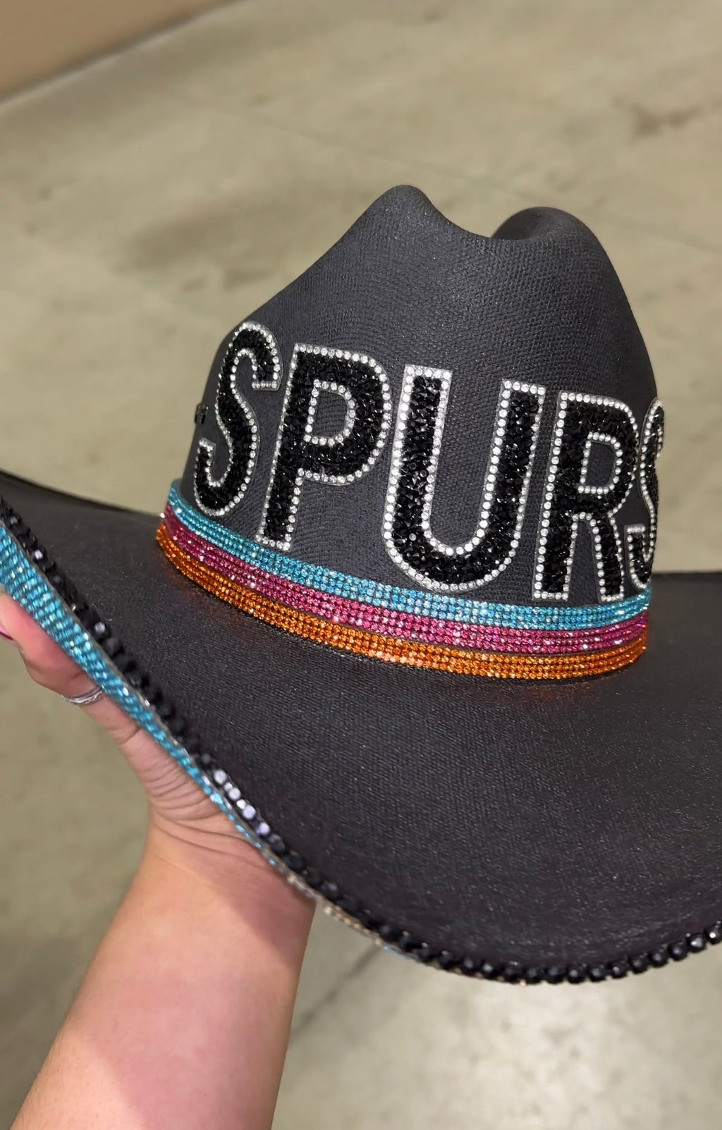 Retro Spurs western-style hat in black, turquoise, orange, and pink colors