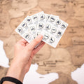 Monochromatic wooden pins featuring Ukrainian landmark icons arranged on a map