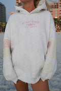 Model wearing a quilted pastel embroidered hoodie with a relaxed unisex fit
