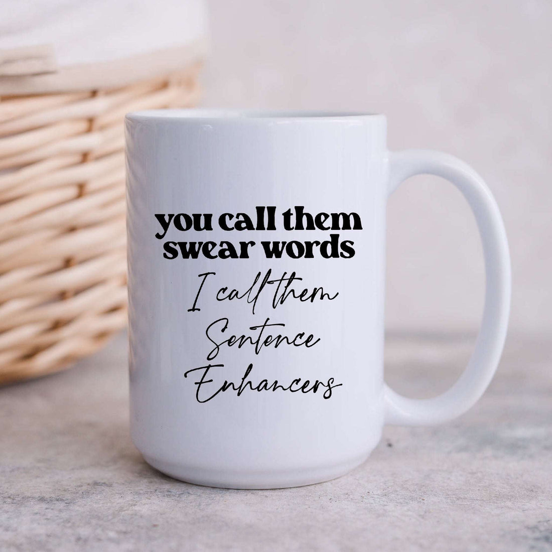 White ceramic coffee mug with text that reads You call them swear words I call them Sentence Enhancers.
