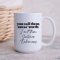White ceramic coffee mug with text that reads You call them swear words I call them Sentence Enhancers.