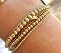 Miss Mini Stack set of 14K gold-filled bead bracelets featuring mixed 2mm, 3mm, and 4mm beads on a white background.