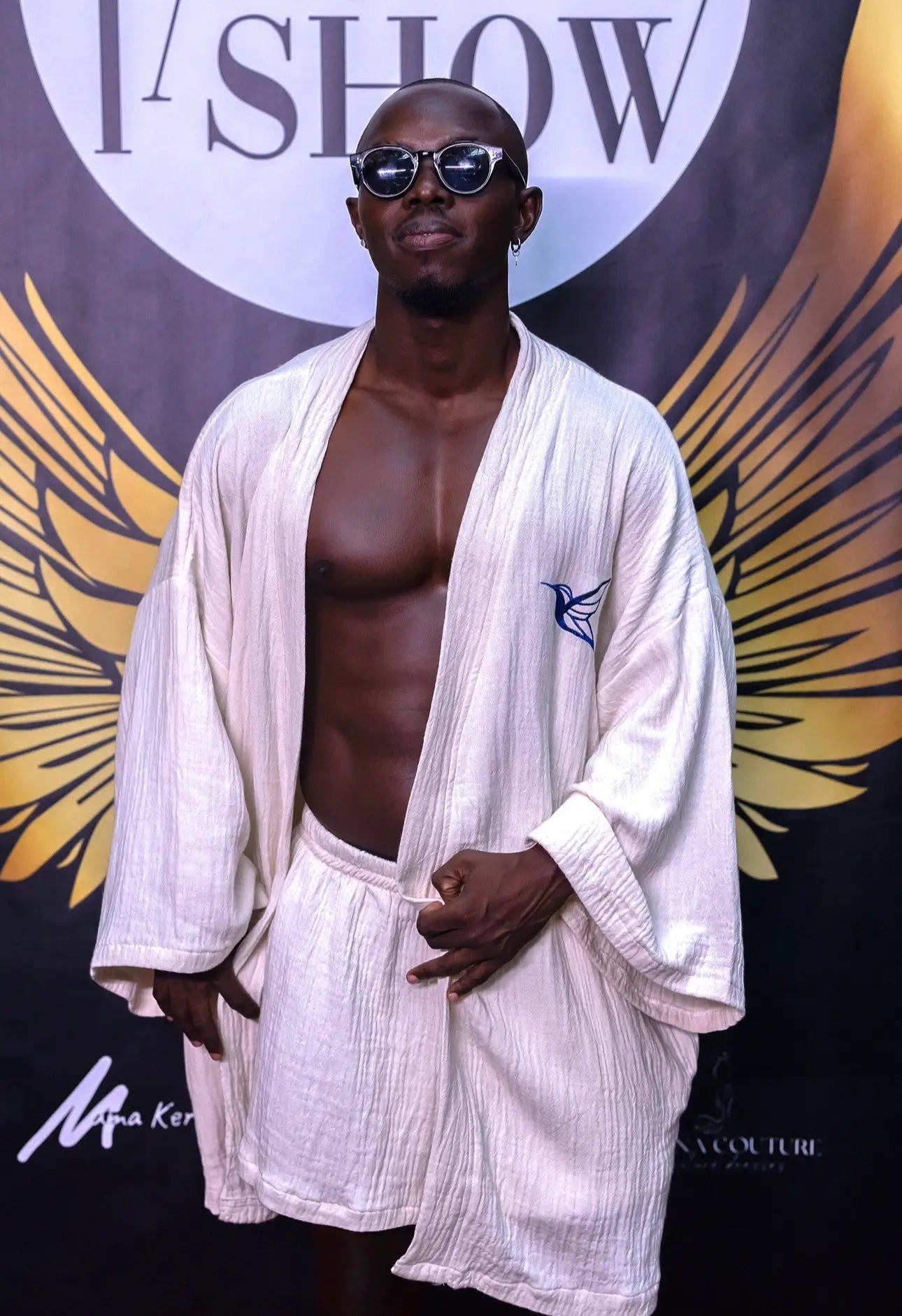 A person wearing a white Turkish cotton robe and matching shorts lounge set.