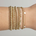 Set of 8 Miss Bold 14K gold-filled bead bracelets worn as a stack for a modern bohemian aesthetic