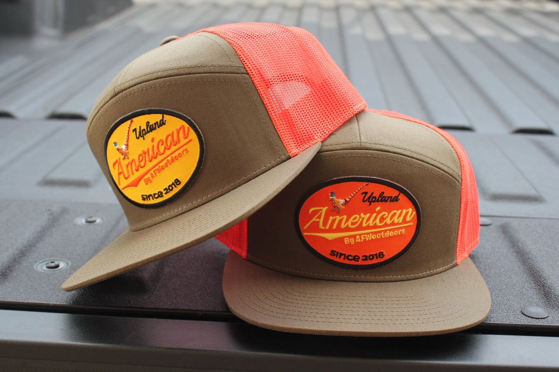 AFW Outdoors 7-panel trucker hat in olive green and bright orange with a flat bill and snapback closure.