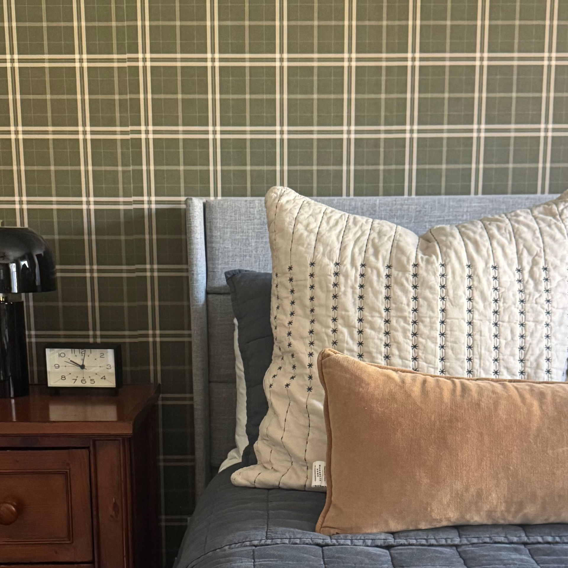 Close-up of Alcott plaid wallpaper in olive green and cream colors for a farmhouse aesthetic.