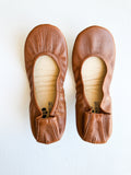 A pair of women's Chestnut Brown ballet flats viewed from above on a white background.