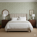 Russ wallpaper featuring sage green background with off-white botanical branch illustrations in a modern bedroom setting