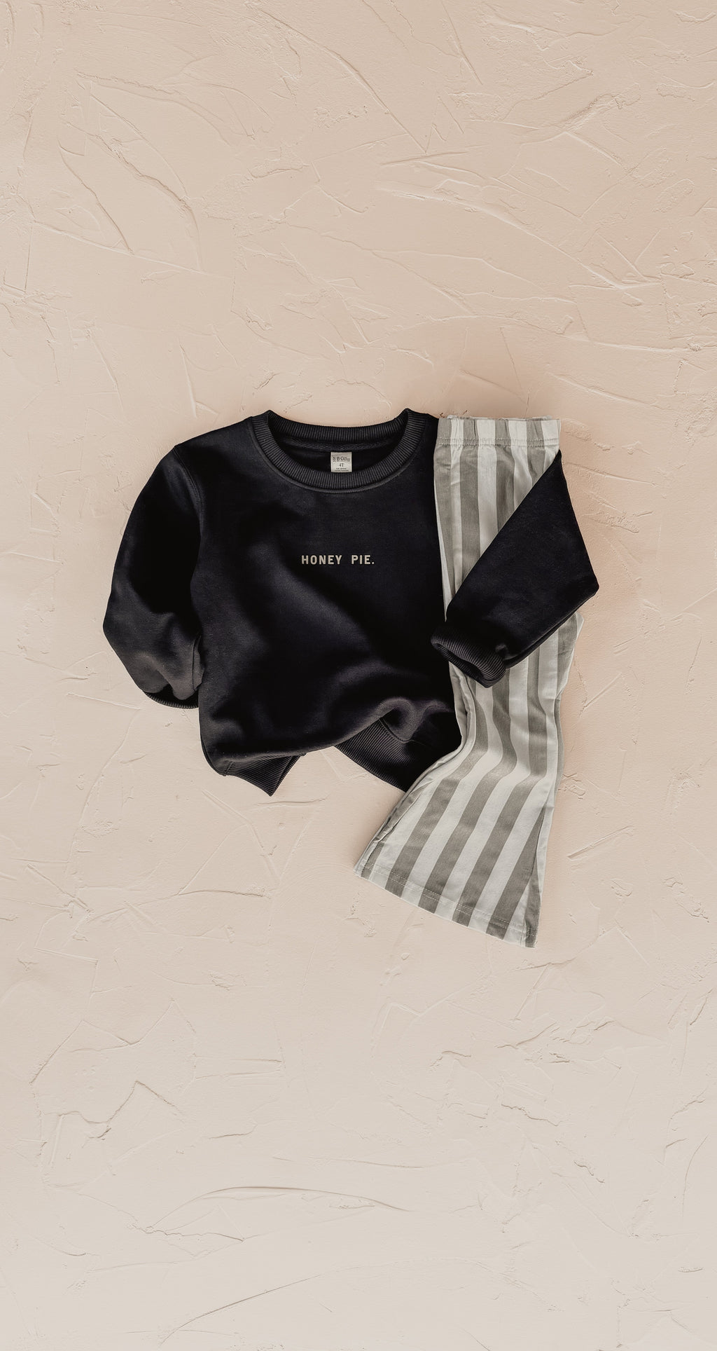 Close up of Honey Pie long sleeve crewneck sweatshirt in a soft unisex kids fit