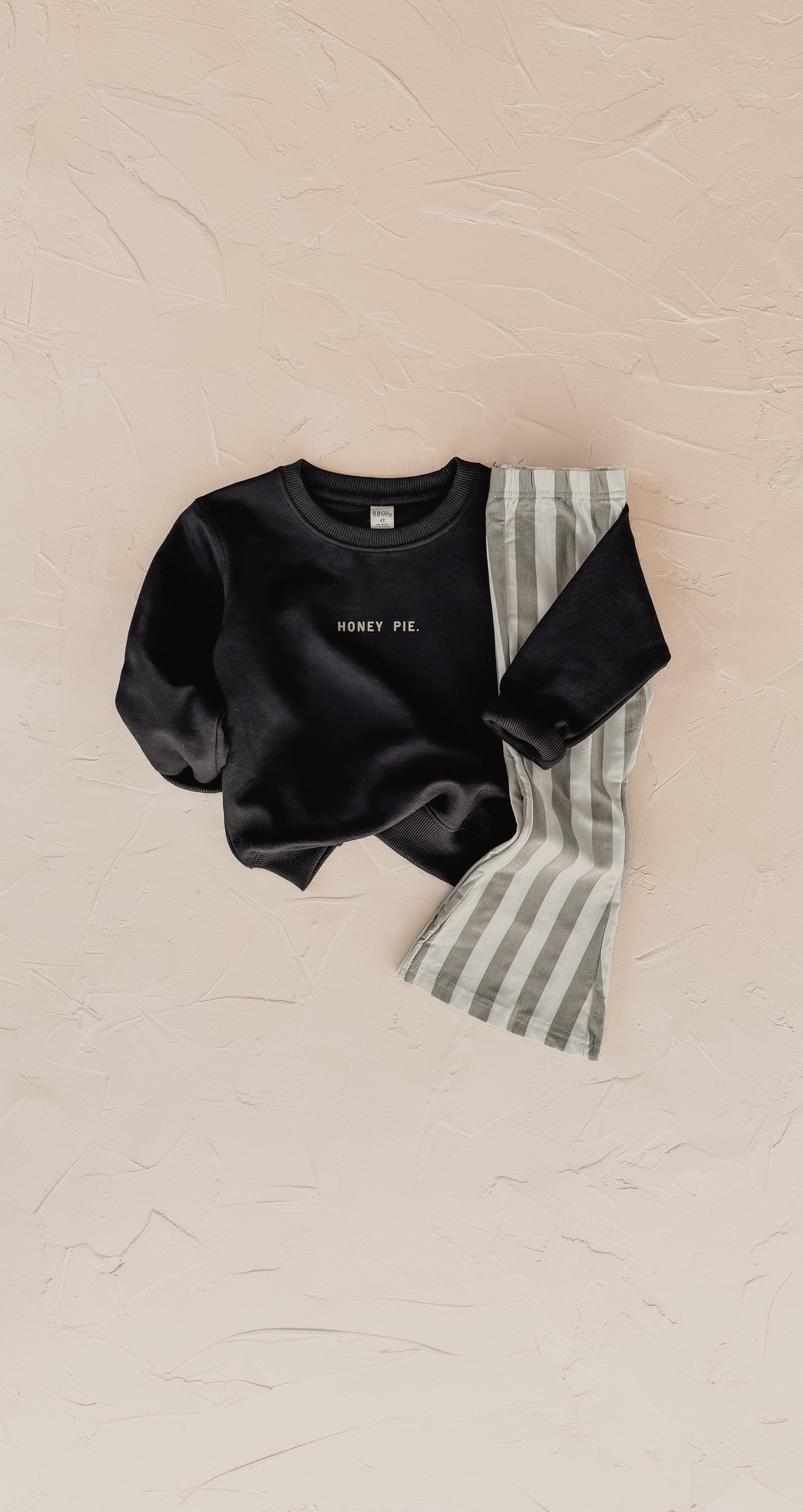 Close up of Honey Pie long sleeve crewneck sweatshirt in a soft unisex kids fit