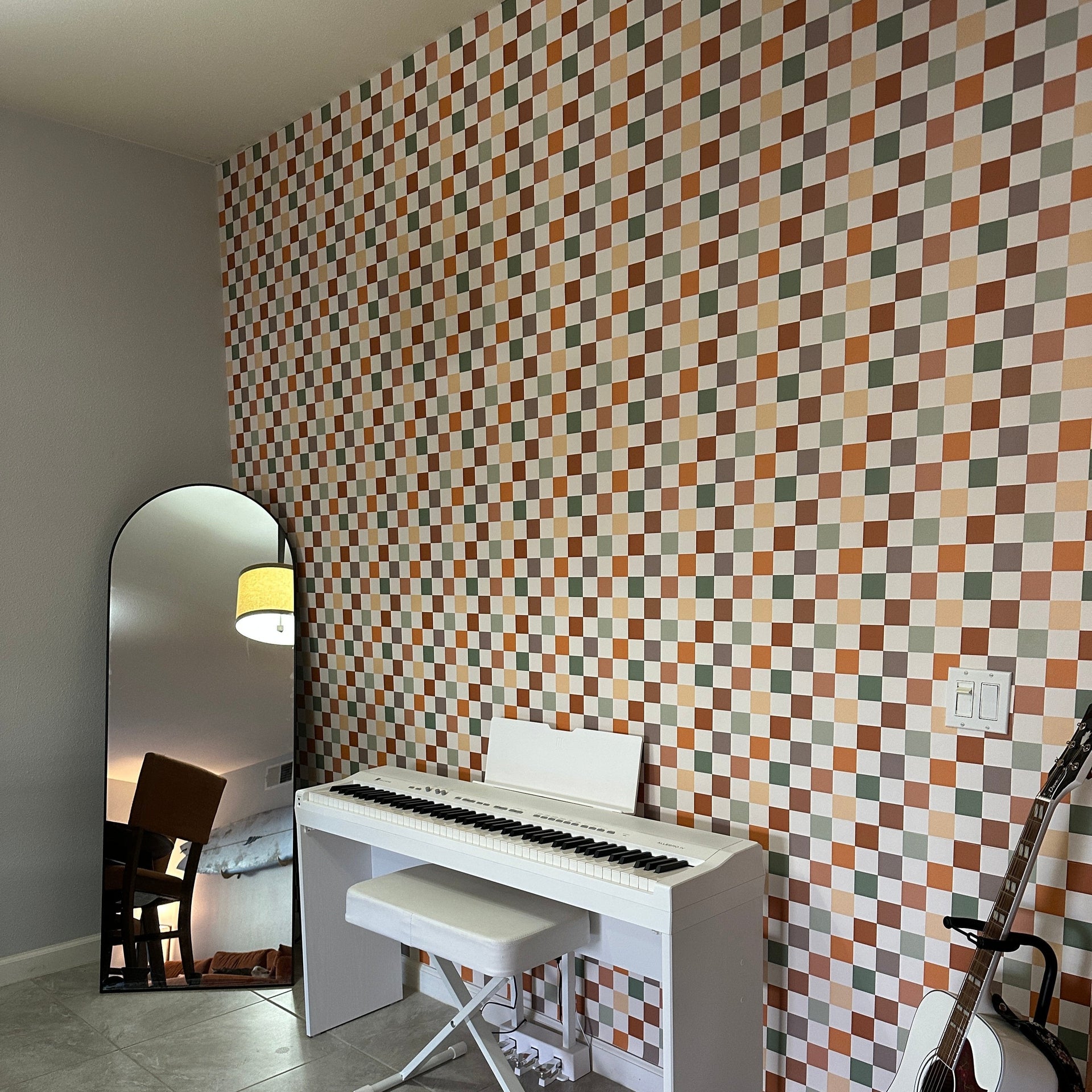 Close up of Beck geometric wallpaper in terracotta, sage-green, cream, and taupe tones